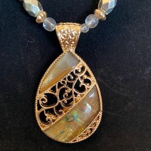 Beautiful beaded necklace with iridescent green stone and gold filigree pendant